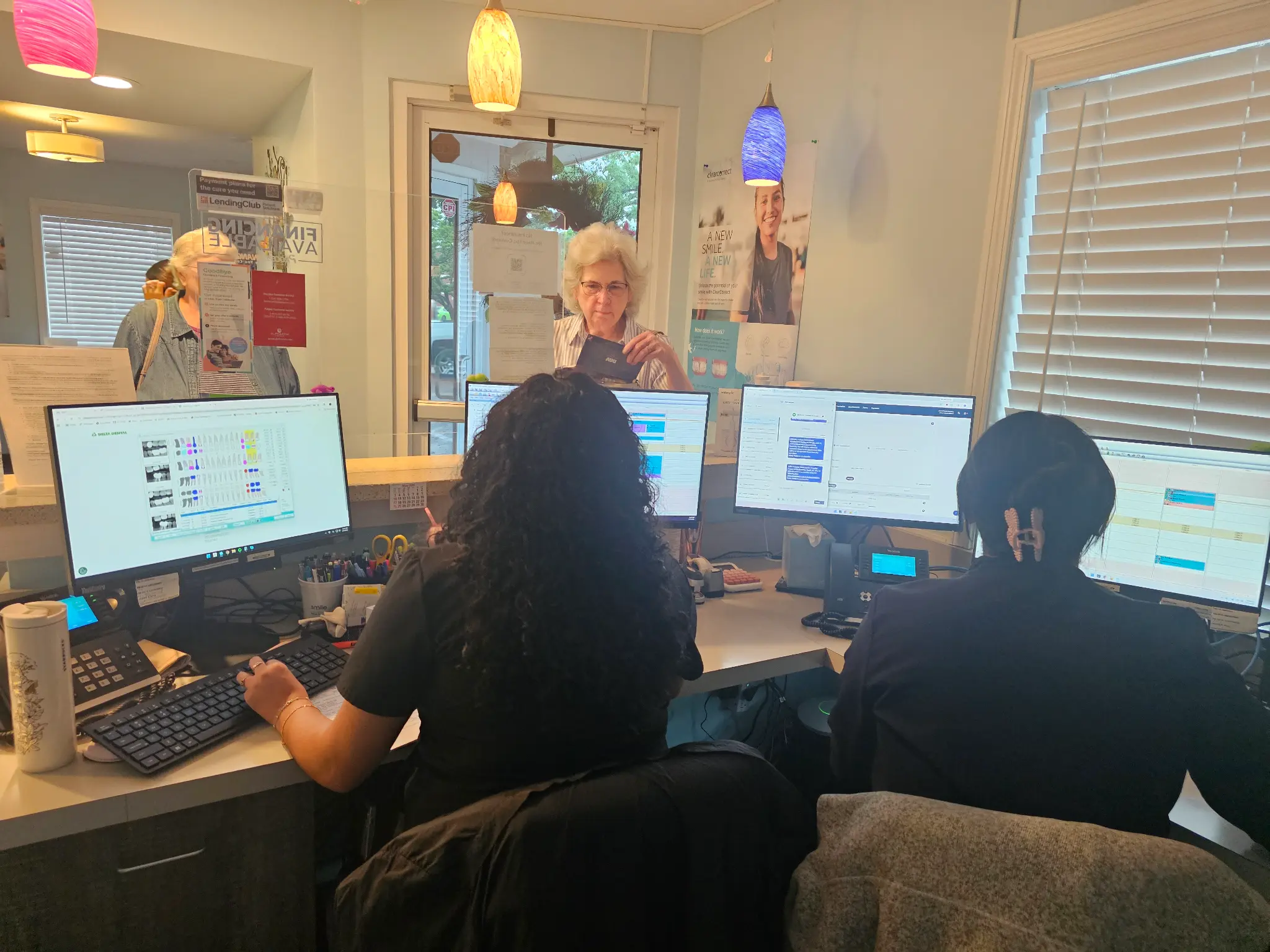 Accent Family Dentistry front desk staff helping patients